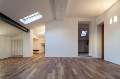 loft conversion with white walls and parquet flooring