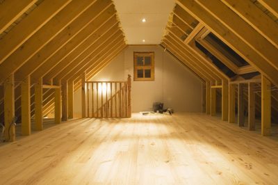 Finished loft conversion with exposed beams and wooden flooring